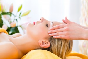 Wellness - woman receiving head or face massage in spa.