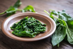 Portion Of Cooked Spinach On The Wooden Table