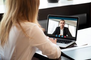 Woman talking to a man through a laptop