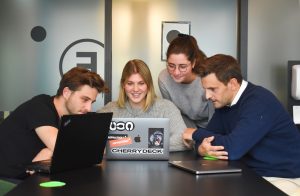 Workers crowded around a laptop