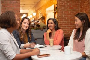 Women sitting around a table chatting